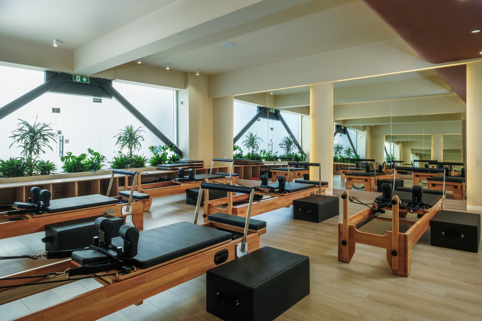 Client stretching on a reformer inside the For.me Pilates studio